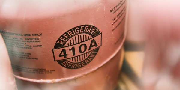 Close-up of an R-410A refrigerant tank, one of the phased-out HVAC refrigerants.