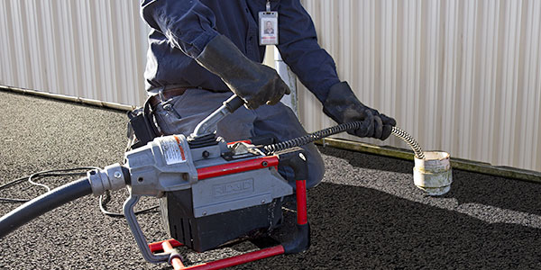 Technician cleaning out a drain line