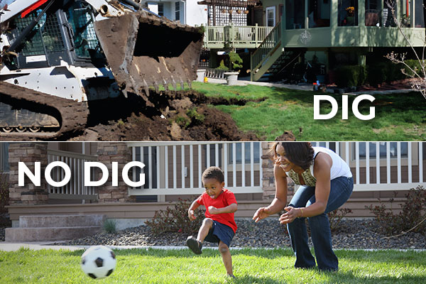 Construction vehicle digging up a yard