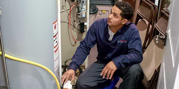 Technician working on a water heater